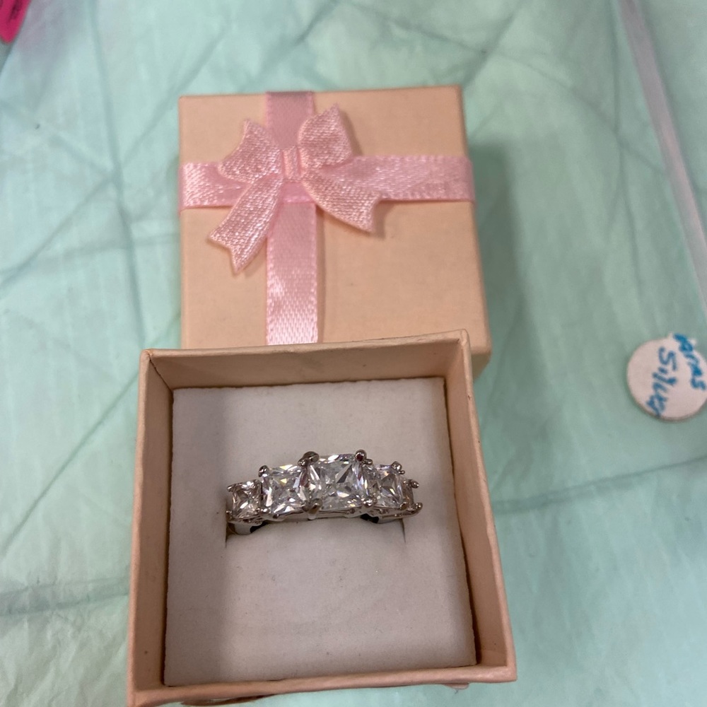 Stainless steel with 5 faux diamonds.